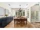 The dining room has a dark buffet, dining table with chairs, and a view of the backyard at 4635 High Point Rd, Atlanta, GA 30342