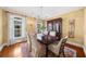 Formal dining room with hardwood floors, chandelier, and views of the garden at 4635 High Point Rd, Atlanta, GA 30342