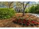 Beautifully landscaped home featuring a classic exterior with a welcoming porch and vibrant flower beds at 4635 High Point Rd, Atlanta, GA 30342