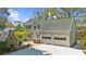 Rear exterior features a backyard with a stone fireplace, attached garage, and a beautiful patio at 4635 High Point Rd, Atlanta, GA 30342