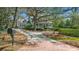 Charming home with lush landscaping, brick driveway, mature trees and inviting front porch at 4635 High Point Rd, Atlanta, GA 30342