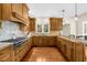 Bright kitchen with a gas range, tile backsplash, wooden cabinetry, and hardwood floors at 4635 High Point Rd, Atlanta, GA 30342