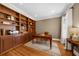 Office with hardwood floors, window, and custom built-in shelving and cabinets at 4635 High Point Rd, Atlanta, GA 30342