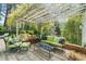 Back patio with string lights, outdoor seating, and views of the private wooded yard at 4635 High Point Rd, Atlanta, GA 30342