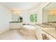 Elegant bathroom featuring a soaking tub, granite counters, and double vanities for a spa-like experience at 570 Glengate Cv, Atlanta, GA 30328