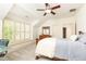 Bedroom with windows and white walls, with a ceiling fan, bed, and desk at 570 Glengate Cv, Atlanta, GA 30328