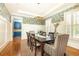 Formal dining room with designer wallpaper, natural light, and a stylish chandelier fixture at 570 Glengate Cv, Atlanta, GA 30328