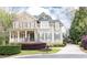 Two-story home with brick and siding, well-maintained landscaping, and inviting front porch and driveway at 570 Glengate Cv, Atlanta, GA 30328