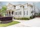 Charming two-story home with brick and siding exterior, manicured landscaping, and inviting front porch at 570 Glengate Cv, Atlanta, GA 30328