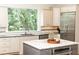 Bright kitchen featuring modern appliances, granite countertops, and a center island with a sink at 570 Glengate Cv, Atlanta, GA 30328