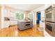 Bright kitchen features stainless appliances, grey kitchen island with marble countertop, and white cabinets at 570 Glengate Cv, Atlanta, GA 30328