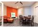 Cozy living area with bright orange accent wall, table and chairs, and comfortable seating at 570 Glengate Cv, Atlanta, GA 30328