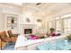 Bright living room features a fireplace, built-in shelving, and French doors to the outside at 570 Glengate Cv, Atlanta, GA 30328