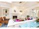 Bright living room features a fireplace, built-in shelving, and French doors to the outside at 570 Glengate Cv, Atlanta, GA 30328