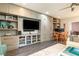 Modern living room featuring built-in storage, stylish decor, and sleek hardwood floors, creating a comfortable and organized space at 570 Glengate Cv, Atlanta, GA 30328