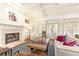 Cozy living room features hardwood floors, fireplace, and French doors leading to the outdoor space at 570 Glengate Cv, Atlanta, GA 30328