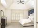 Serene main bedroom with tray ceiling, large window, and an ensuite bathroom entrance at 570 Glengate Cv, Atlanta, GA 30328
