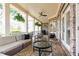 Relaxing covered patio with brick flooring, comfortable seating, and ceiling fan for outdoor enjoyment at 570 Glengate Cv, Atlanta, GA 30328