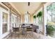 Inviting covered patio featuring brick flooring, ample seating, and ceiling fan for comfortable outdoor living at 570 Glengate Cv, Atlanta, GA 30328