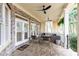 Charming covered patio with brick flooring, seating, and views of the surrounding greenery for peaceful relaxation at 570 Glengate Cv, Atlanta, GA 30328
