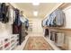 Large walk-in closet with custom shelving and storage, featuring an ornate rug and ample space for clothing at 570 Glengate Cv, Atlanta, GA 30328