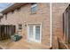 Enclosed brick patio with white double doors offering a private outdoor space at 7 Villa Se Ct, Smyrna, GA 30080
