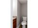 Half bathroom featuring laminate flooring, granite counters, and white fixtures at 7 Villa Se Ct, Smyrna, GA 30080