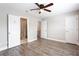 Spacious bedroom with hardwood floors, a ceiling fan, and multiple entryways at 7 Villa Se Ct, Smyrna, GA 30080