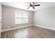 Bedroom with a ceiling fan and large windows, features beautiful hardwood floors at 7 Villa Se Ct, Smyrna, GA 30080
