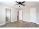 This bedroom features hardwood floors, a ceiling fan, and entryways at 7 Villa Se Ct, Smyrna, GA 30080