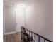 Hallway with hardwood floors and iron railing staircase leading to the upper level at 7 Villa Se Ct, Smyrna, GA 30080