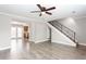Open living area with laminate flooring, staircase and seamless flow into adjacent kitchen at 7 Villa Se Ct, Smyrna, GA 30080