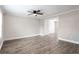 Spacious living room featuring new laminate flooring, neutral paint, and a modern ceiling fan at 7 Villa Se Ct, Smyrna, GA 30080