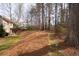 Expansive backyard featuring a stone path, lush greenery, and an inviting patio area at 706 Registry Run, Kennesaw, GA 30152