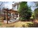 Backyard patio featuring a wood pergola and charming hammock swings at 706 Registry Run, Kennesaw, GA 30152