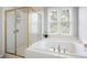 Bathroom with shower over large soaking tub and natural lighting at 706 Registry Run, Kennesaw, GA 30152