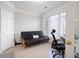 Cozy bedroom area with a futon couch near the window, and an office chair by the desk at 706 Registry Run, Kennesaw, GA 30152
