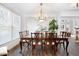 Bright dining room with a wood table, chandelier, and natural light from the large windows at 706 Registry Run, Kennesaw, GA 30152