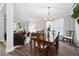 Bright dining room with a chandelier, hardwood table, and view of the living room at 706 Registry Run, Kennesaw, GA 30152