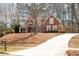 Charming two-story brick home with a long, inviting driveway surrounded by mature trees at 706 Registry Run, Kennesaw, GA 30152