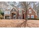 Beautiful brick and stone home with manicured lawn and mature trees in a quiet neighborhood at 706 Registry Run, Kennesaw, GA 30152