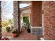 Charming brick porch with potted flowers and white railings offers a cozy outdoor space at 706 Registry Run, Kennesaw, GA 30152