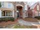 Inviting front porch featuring brick and stone pillars, potted plants, and a charming entrance at 706 Registry Run, Kennesaw, GA 30152
