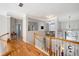 Bright hallway with hardwood floors that overlooks the living room below, and leads to the home entrance at 706 Registry Run, Kennesaw, GA 30152