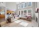 Open-concept living room with hardwood floors, a fireplace, and kitchen view with natural lighting at 706 Registry Run, Kennesaw, GA 30152