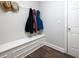 Bright mudroom featuring a white bench with storage underneath, coat hooks and hats for decor at 706 Registry Run, Kennesaw, GA 30152