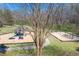 Community playground features a jungle gym, climbing wall, swings, and cushioned flooring at 706 Registry Run, Kennesaw, GA 30152