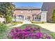 Manicured backyard features a well-maintained lawn, vibrant flowerbeds, and a charming outdoor living space at 825 Glengate Pl, Atlanta, GA 30328