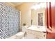 Clean bathroom with white vanity, mirror, and shower with a stylish blue patterned curtain at 825 Glengate Pl, Atlanta, GA 30328