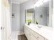 Bathroom featuring double sinks with white cabinets, a large mirror, tile floors, and a shower with a curtain at 825 Glengate Pl, Atlanta, GA 30328